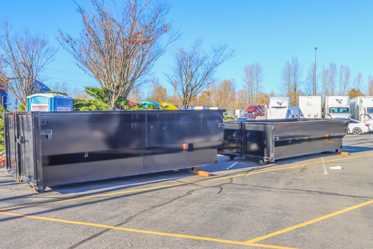 Professional dumpster rental service with roll-off container on residential driveway in Adel